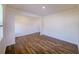 Open living room featuring wood-look floors, neutral paint, and a bright, airy feel from ample lighting at 4420 Merrigold Way, Fairburn, GA 30213