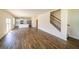 Open-concept living area features a stairway, kitchen with stainless steel appliances, and hardwood floors at 4420 Merrigold Way, Fairburn, GA 30213