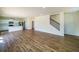 Spacious open-concept living area with hardwood floors, a stairway, and a modern kitchen with stainless appliances at 4420 Merrigold Way, Fairburn, GA 30213