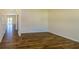 Living room with wood-look floors, neutral paint, bright natural light and an open concept design at 4420 Merrigold Way, Fairburn, GA 30213