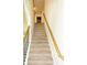 Carpeted stairway with wood railings leads to the upper level of the home at 4420 Merrigold Way, Fairburn, GA 30213