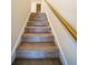 Carpeted stairway features a wood handrail leading to the upper level at 4420 Merrigold Way, Fairburn, GA 30213