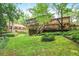Lush backyard with green grass, established landscaping, and a deck perfect for enjoying the outdoors at 850 John Alden Rd, Stone Mountain, GA 30083