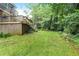Well-maintained backyard with ample green space, mature trees, and a deck at 850 John Alden Rd, Stone Mountain, GA 30083