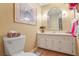 Cozy bathroom with a single sink vanity, neutral wall color, and unique tile flooring at 850 John Alden Rd, Stone Mountain, GA 30083