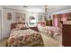 Well-lit bedroom with two beds, floral patterned bedding, and a neutral color palette at 850 John Alden Rd, Stone Mountain, GA 30083
