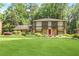 Charming two-story home with a well-manicured lawn and lush landscaping at 850 John Alden Rd, Stone Mountain, GA 30083