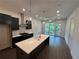 Contemporary kitchen featuring a large island, stainless steel appliances, and stylish pendant lighting at 962 Bibbs Circle Nw # 6, Atlanta, GA 30318
