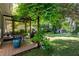 Charming back porch with a pergola covered in lush greenery, creating a peaceful outdoor retreat with a dining area at 1071 Standard Ne Dr, Brookhaven, GA 30319
