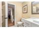 Bright bathroom with tile floors, modern vanity, toilet and partial view of a tile and glass shower at 1071 Standard Ne Dr, Brookhaven, GA 30319