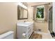 Bathroom featuring shaker vanity, modern faucet, stone floors, large mirror and nature view window at 1071 Standard Ne Dr, Brookhaven, GA 30319