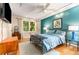 Stylish bedroom with teal accent wall, track lighting, and large window at 1071 Standard Ne Dr, Brookhaven, GA 30319