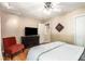 Cozy bedroom features a ceiling fan, TV, dark dresser, and closet at 1071 Standard Ne Dr, Brookhaven, GA 30319