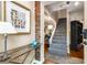 Foyer with wood floors, staircase, and brick accent wall, leading into an inviting living space at 1071 Standard Ne Dr, Brookhaven, GA 30319