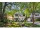 Charming two-story home with a brick foundation, a well-manicured lawn, carport, and mature trees at 1071 Standard Ne Dr, Brookhaven, GA 30319