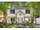 Charming two-story home with a brick foundation, a well-manicured lawn, and mature trees at 1071 Standard Ne Dr, Brookhaven, GA 30319