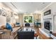 Inviting living room with hardwood floors, a fireplace, and a large window showcasing the outdoor view at 1071 Standard Ne Dr, Brookhaven, GA 30319