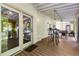 Cozy screened-in porch with dining table, bar stools, and wooden floors at 1071 Standard Ne Dr, Brookhaven, GA 30319