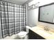 Well-lit bathroom featuring a shower with curtain, sleek vanity and mirror at 2674 Misty Rock Cv, Dacula, GA 30019