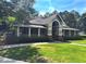 Community clubhouse with welcoming entrance, covered porch, and manicured landscaping at 2674 Misty Rock Cv, Dacula, GA 30019