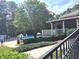Community pool with lounge chairs, umbrellas, and mature shade trees for relaxation at 2674 Misty Rock Cv, Dacula, GA 30019