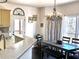 Inviting dining area with modern chandelier and access to outdoor deck with lots of light at 2674 Misty Rock Cv, Dacula, GA 30019