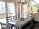 Dining area featuring modern chandelier, table with seating and sliding glass door for outdoor access at 2674 Misty Rock Cv, Dacula, GA 30019