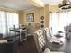 Stylish dining area featuring a modern chandelier, designer seating, and view into the office area at 2674 Misty Rock Cv, Dacula, GA 30019