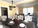 Elegant dining room with a dark wood table, upholstered chairs, and views into the living room at 2674 Misty Rock Cv, Dacula, GA 30019