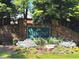 Stone entrance sign to Apalachee River Club with lush landscaping and seasonal flowers at 2674 Misty Rock Cv, Dacula, GA 30019