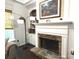 Living room fireplace with stone surround, flanked by built-in shelving units at 2674 Misty Rock Cv, Dacula, GA 30019