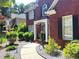 Inviting brick home with manicured landscaping, a curved walkway, and a covered front entrance at 2674 Misty Rock Cv, Dacula, GA 30019