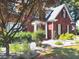 Beautiful brick home with a well-maintained yard featuring mature trees, shrubs, and a charming front entrance at 2674 Misty Rock Cv, Dacula, GA 30019