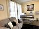 Bright home office with a comfortable couch, modern desk, and neutral décor at 2674 Misty Rock Cv, Dacula, GA 30019
