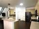 Modern kitchen featuring light wood cabinets, stainless steel appliances, breakfast bar, and tile backsplash at 2674 Misty Rock Cv, Dacula, GA 30019