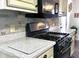 Kitchen showcases stone backsplash, light cabinets, stainless steel range and countertops at 2674 Misty Rock Cv, Dacula, GA 30019