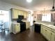 Spacious kitchen with modern cabinets, black appliances, breakfast nook, and hardwood floors at 2674 Misty Rock Cv, Dacula, GA 30019