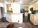 Open kitchen with modern appliances, light countertops, dark floors, and a breakfast bar at 2674 Misty Rock Cv, Dacula, GA 30019