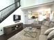 Open-concept living room showcasing staircase, entertainment center, and inviting sectional sofa at 2674 Misty Rock Cv, Dacula, GA 30019