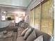 Comfortable living room featuring large windows with woven shades and inviting sectional sofa at 2674 Misty Rock Cv, Dacula, GA 30019