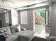 Comfortable living room featuring a gray sectional couch and backyard access at 2674 Misty Rock Cv, Dacula, GA 30019