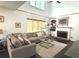 Spacious living room with a plush sectional sofa, stone fireplace, and large windows at 2674 Misty Rock Cv, Dacula, GA 30019