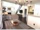 Open-concept living space features a fireplace, kitchen, and dining area with stylish chandelier at 2674 Misty Rock Cv, Dacula, GA 30019