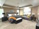 Spacious bedroom with king bed, sitting area, neutral tones, and ample natural light at 2674 Misty Rock Cv, Dacula, GA 30019