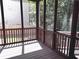 Cozy screened porch with wooden floors and wooded views at 2674 Misty Rock Cv, Dacula, GA 30019