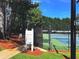 Tennis court with a lush green surrounding and clear posted rules and regulations at 2674 Misty Rock Cv, Dacula, GA 30019
