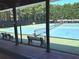 Outdoor tennis court with blue and green surface, surrounded by benches and tall trees at 2674 Misty Rock Cv, Dacula, GA 30019