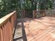 A wooden deck with railings overlooking a beautiful landscape at 2674 Misty Rock Cv, Dacula, GA 30019