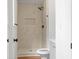 Updated shower with decorative tile, modern fixtures, and a built in shelf at 3735 Benchmark Dr, Atlanta, GA 30349