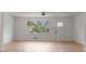 Open living room with new floors, lots of natural light, and a modern ceiling fan at 3735 Benchmark Dr, Atlanta, GA 30349